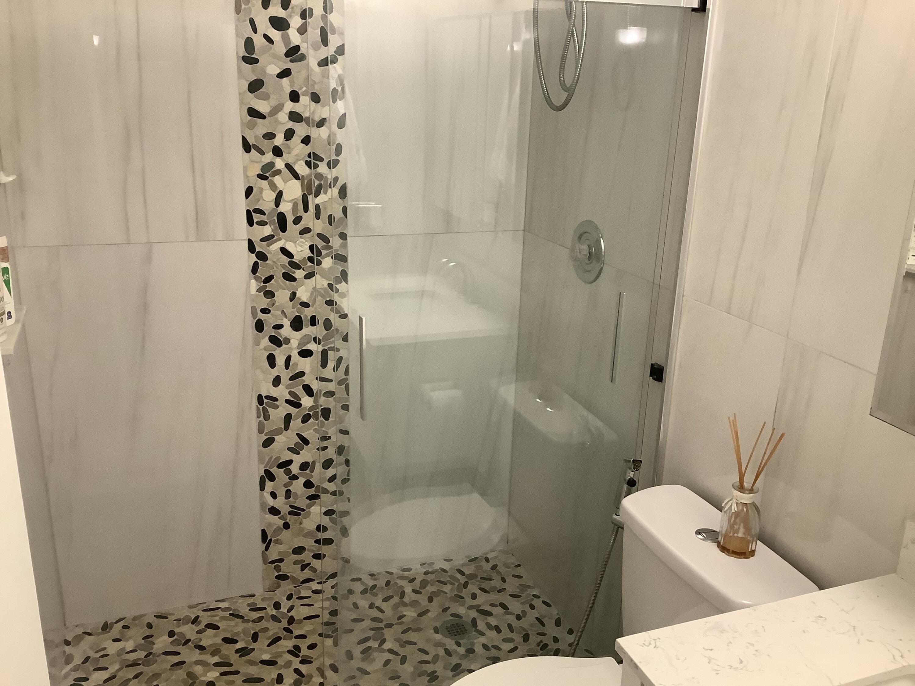 22040 Palms Way, Unit 204 Boca Raton, FL 33433 - Photo 18 of 20 a bathroom with a shower and a toilet