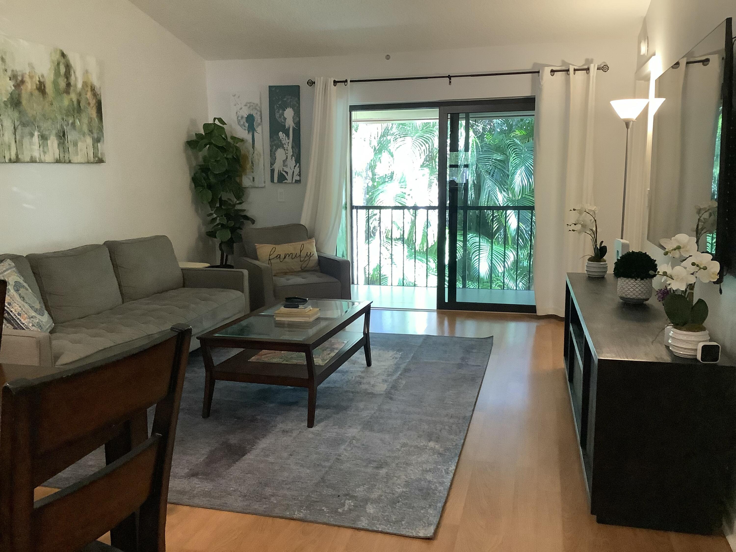 22040 Palms Way, Unit 204 Boca Raton, FL 33433 - Photo 7 of 20 a living room with furniture and a window