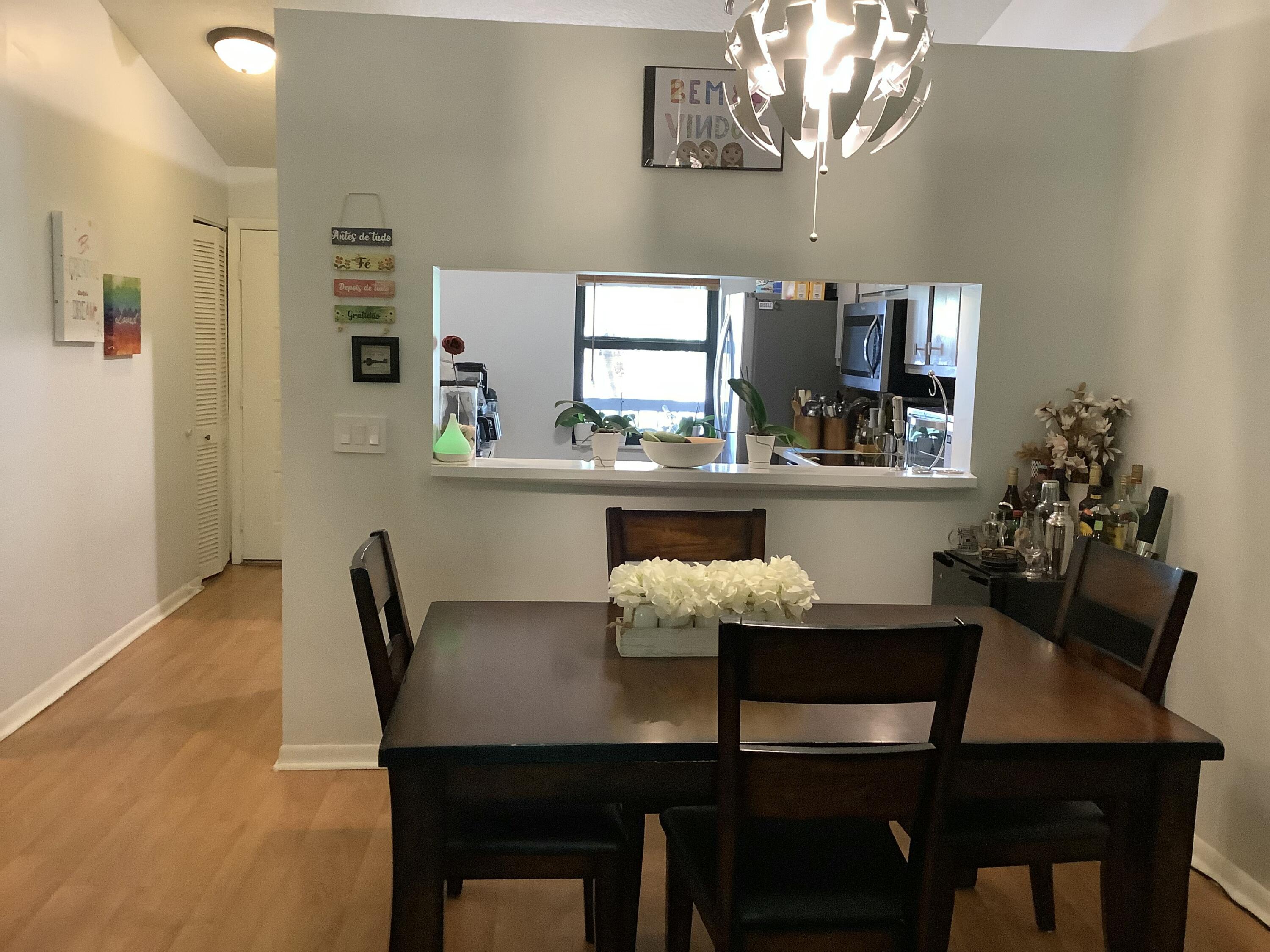 22040 Palms Way, Unit 204 Boca Raton, FL 33433 - Photo 9 of 20 a dining room with furniture and window