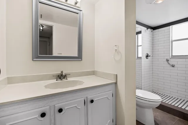 a bathroom with a toilet and a shower