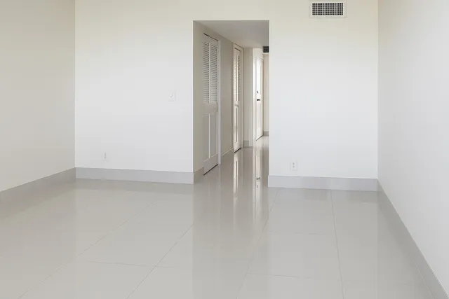 a bathroom with a toilet a window and a shower