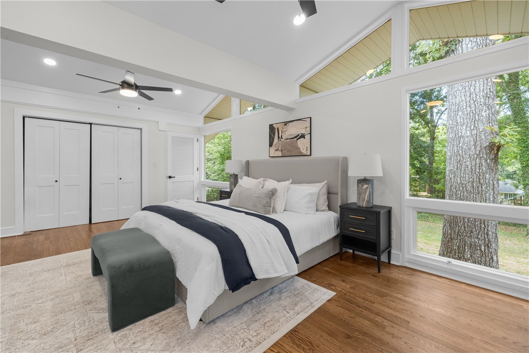 251 Riggs Drive Clemson, SC 29631 - Photo 21 of 37 High vaulted ceilings and large windows highlight this bedroom with hardwood flooring.
