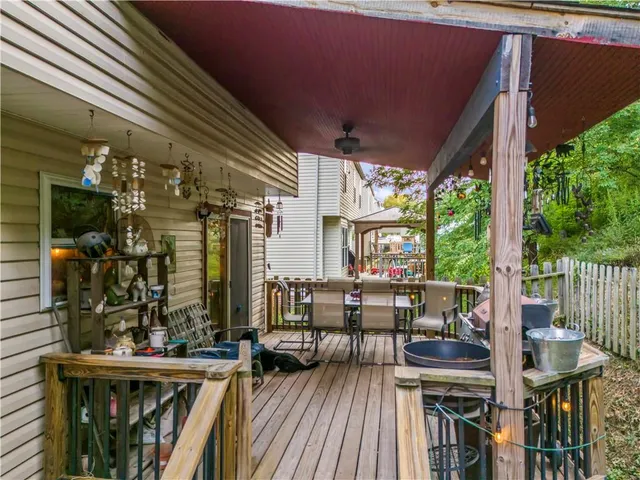 a view of a chairs and table in patio with a barbeque