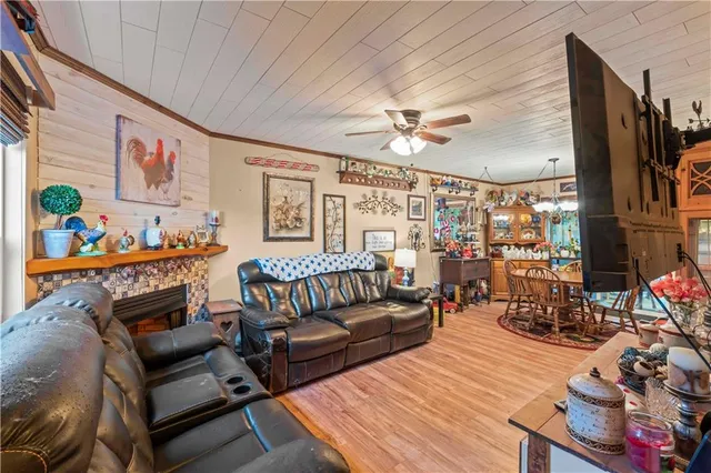 a living room with furniture a fireplace and a flat screen tv