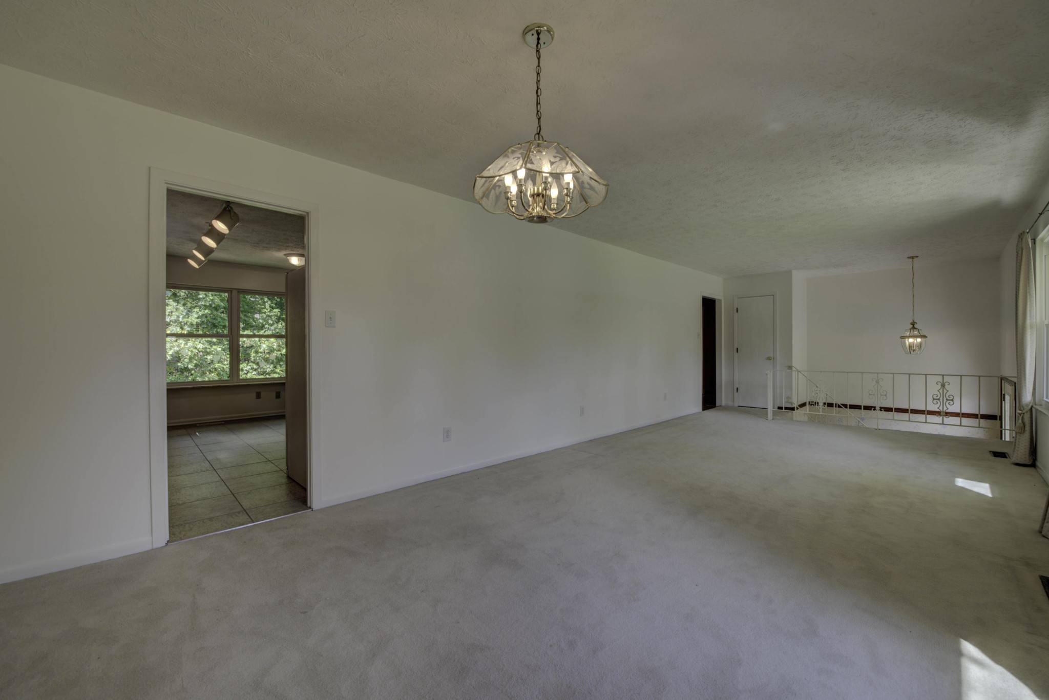 118 Garnet Lane Oak Ridge, TN 37830 - Photo 5 of 28 a view of an empty room with chandelier and kitchen view