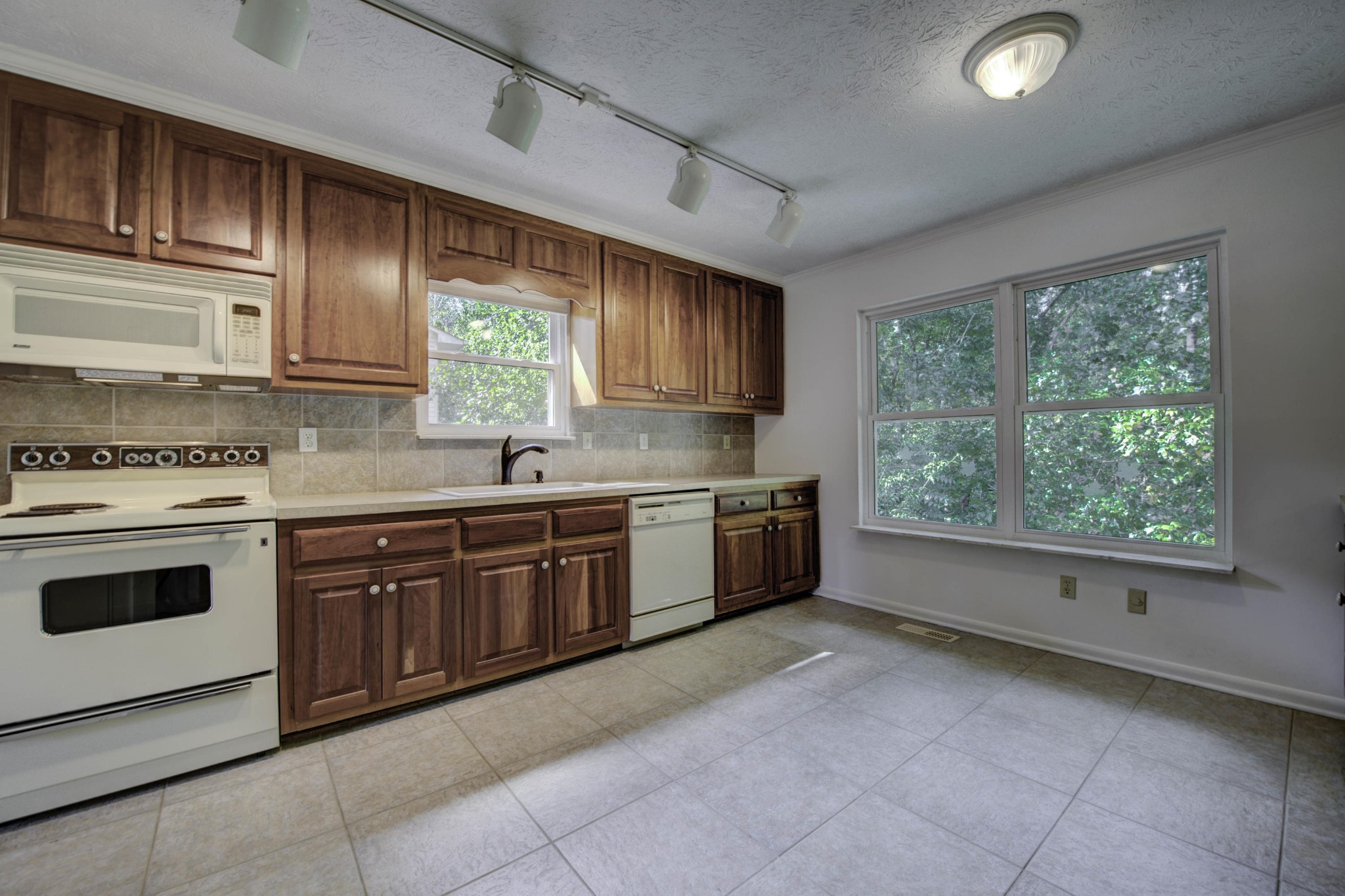 118 Garnet Lane Oak Ridge, TN 37830 - Photo 9 of 28 a kitchen with stainless steel appliances granite countertop a stove sink and cabinets