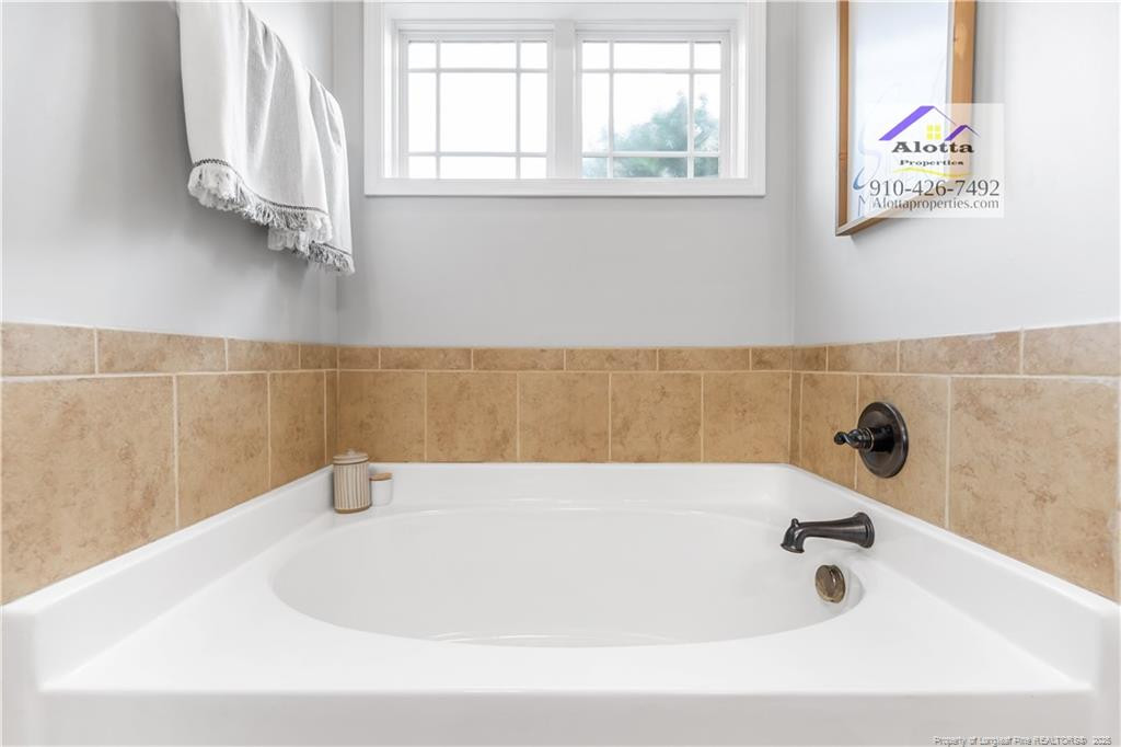 4112 Newgate Street Fayetteville, NC 28306 - Photo 16 of 32 a bathroom with a tub
