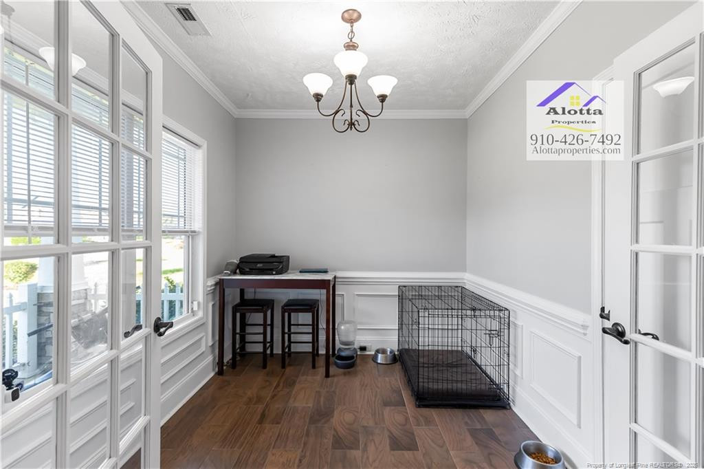 4112 Newgate Street Fayetteville, NC 28306 - Photo 2 of 32 a view of a hallway with wooden floor and staircase