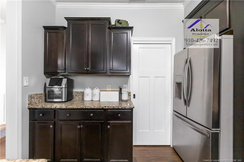 4112 Newgate Street Fayetteville, NC 28306 - Photo 7 of 32 a kitchen with stainless steel appliances granite countertop a refrigerator and a sink