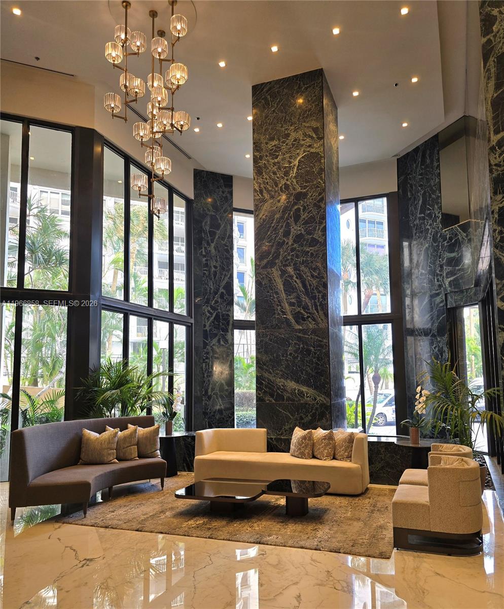 10175 Collins Avenue, Unit 208 Bal Harbour, FL 33154 - Photo 1 of 16 a living room with furniture and a large window