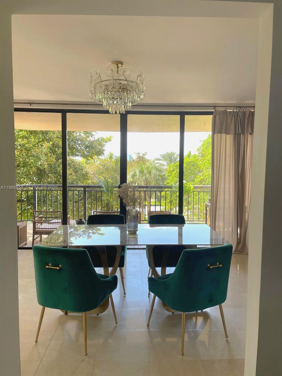 10175 Collins Avenue, Unit 208 Bal Harbour, FL 33154 - Photo 5 of 16 a view of a dining room with furniture window and outside view