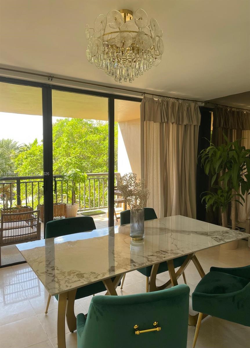 10175 Collins Avenue, Unit 208 Bal Harbour, FL 33154 - Photo 6 of 16 a view of a dining room with furniture window and outside view