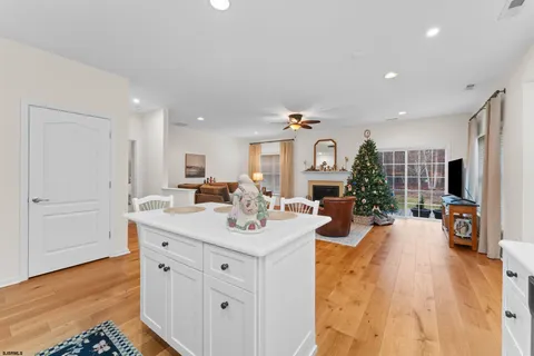 a view of a kitchen counter top space with furniture and wooden floor