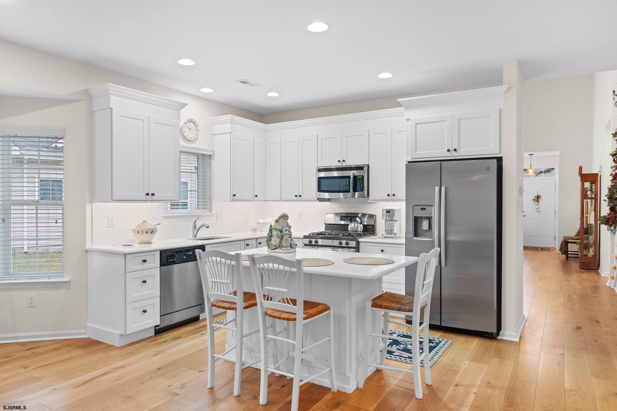 11 Daffodil Road Egg Harbor Township, NJ 08234 - Photo 12 of 50 a kitchen with stainless steel appliances kitchen island granite countertop a refrigerator and a stove top oven