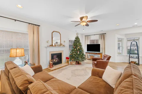 a living room with furniture a fireplace and a flat screen tv