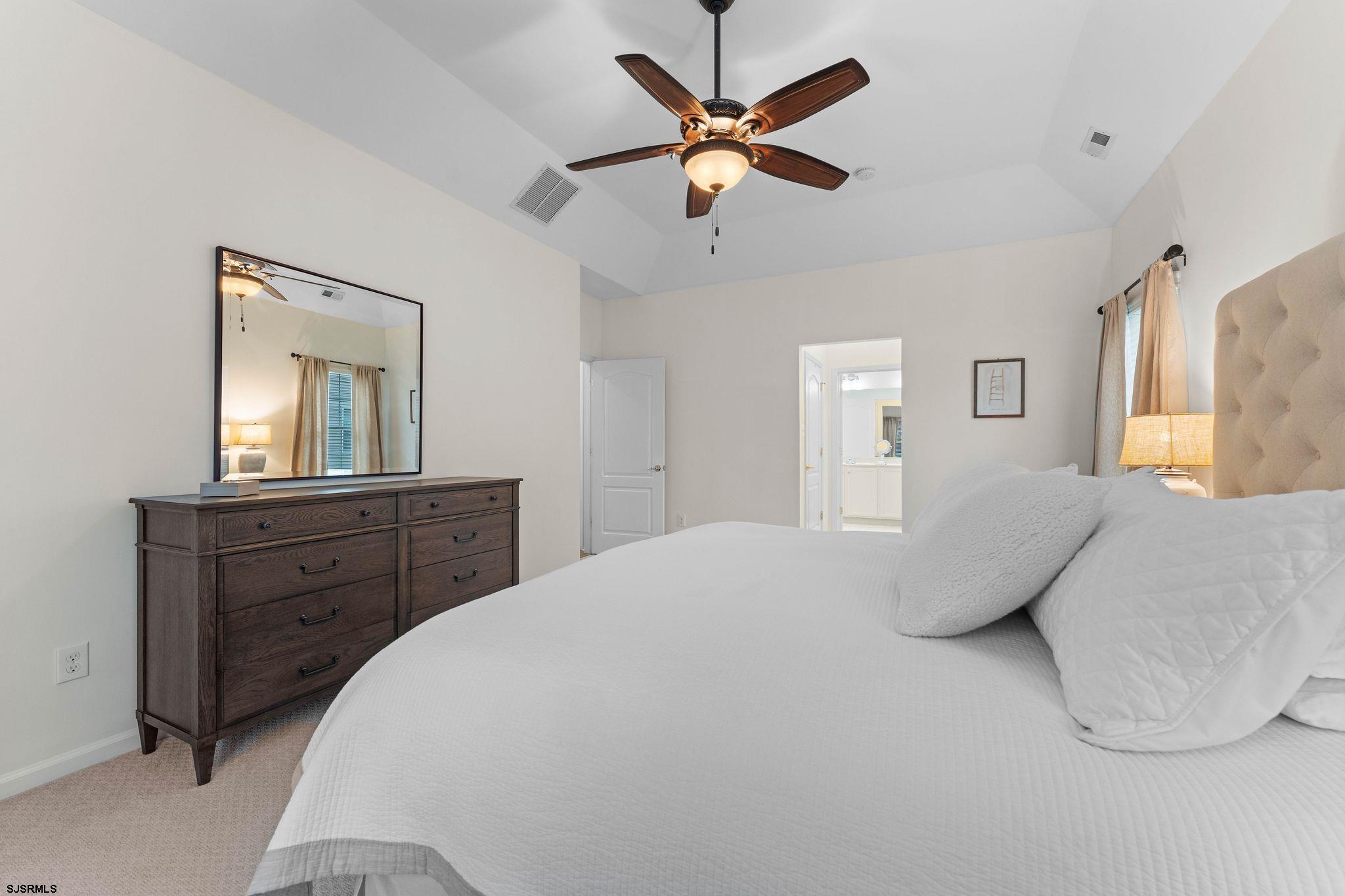 11 Daffodil Road Egg Harbor Township, NJ 08234 - Photo 19 of 50 a bedroom with a large bed and a chandelier