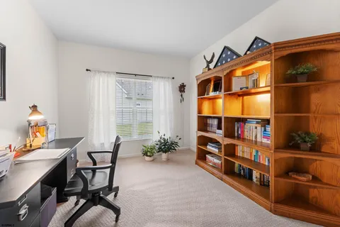 a workspace room with furniture and book shelf