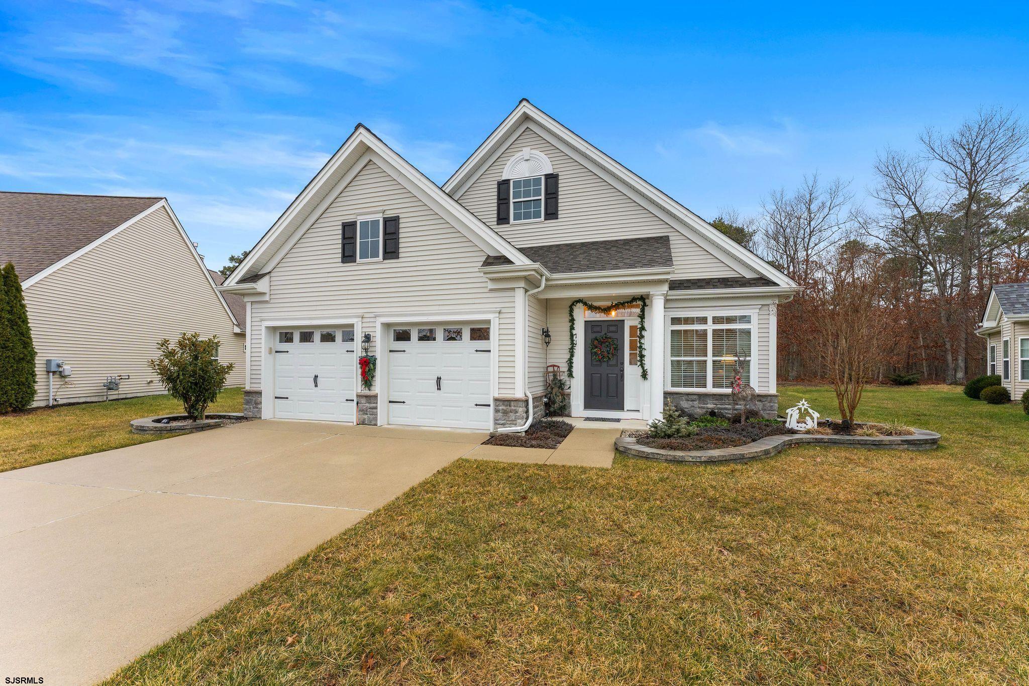11 Daffodil Road Egg Harbor Township, NJ 08234 - Photo 3 of 50 a front view of a house with a yard and garage