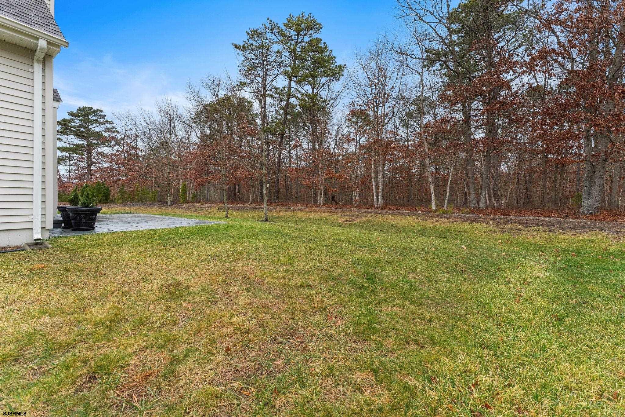 11 Daffodil Road Egg Harbor Township, NJ 08234 - Photo 35 of 50 a backyard of apartments with large trees