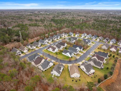 an aerial view of residential houses with outdoor space