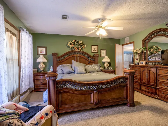 a bedroom with furniture and wooden floor