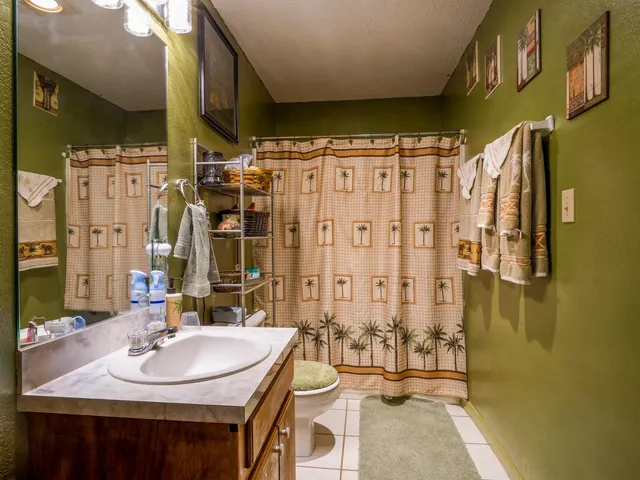 a bathroom with double vanity and a shower