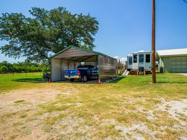 a house view with swimming pool and trees in the background