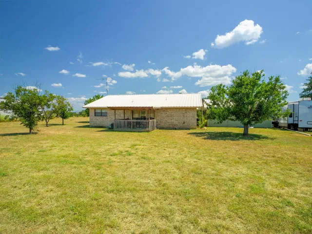 a view of a house with a yard and a porch
