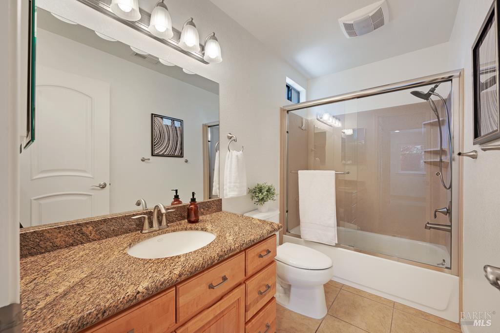 204 Foss Creek Circle, Unit B Healdsburg, CA 95448 - Photo 15 of 19 a bathroom with a granite countertop sink toilet and shower