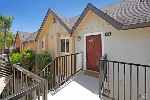 a view of a house with wooden fence and windows