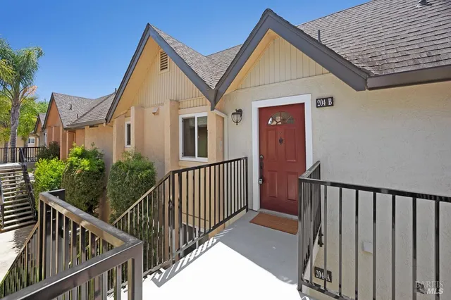a view of a house with wooden fence and windows