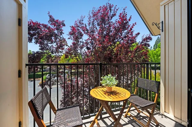 a view of a chairs and table in the balcony