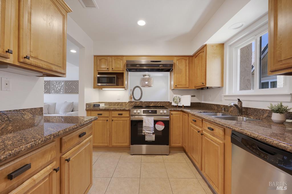 204 Foss Creek Circle, Unit B Healdsburg, CA 95448 - Photo 9 of 19 a kitchen with stainless steel appliances granite countertop a stove sink and cabinets
