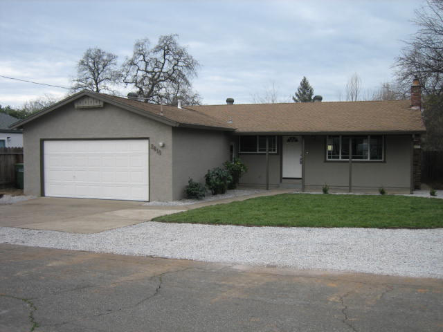 2610 Irwin Road Redding, CA 96002 - Photo 1 of 27 a front view of a house with a yard and garage