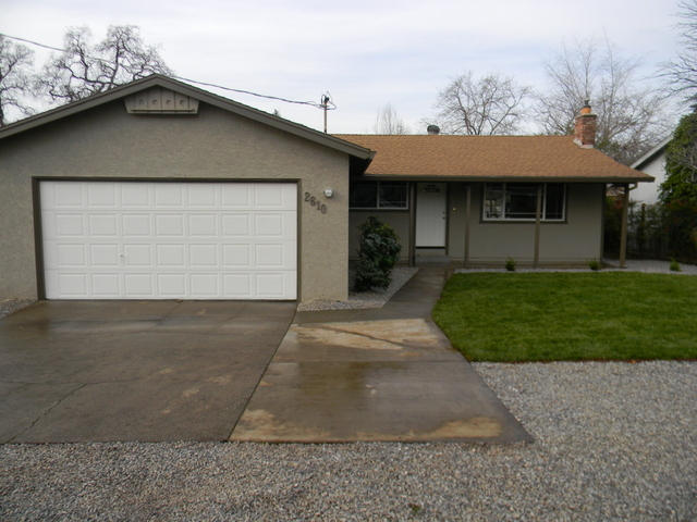 2610 Irwin Road Redding, CA 96002 - Photo 2 of 27 a front view of a house with a yard and garage