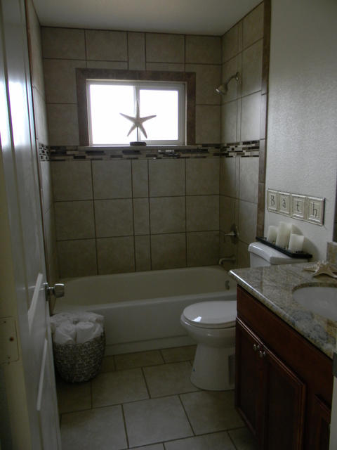 2610 Irwin Road Redding, CA 96002 - Photo 22 of 27 a bathroom with a granite countertop sink a toilet a window and shower