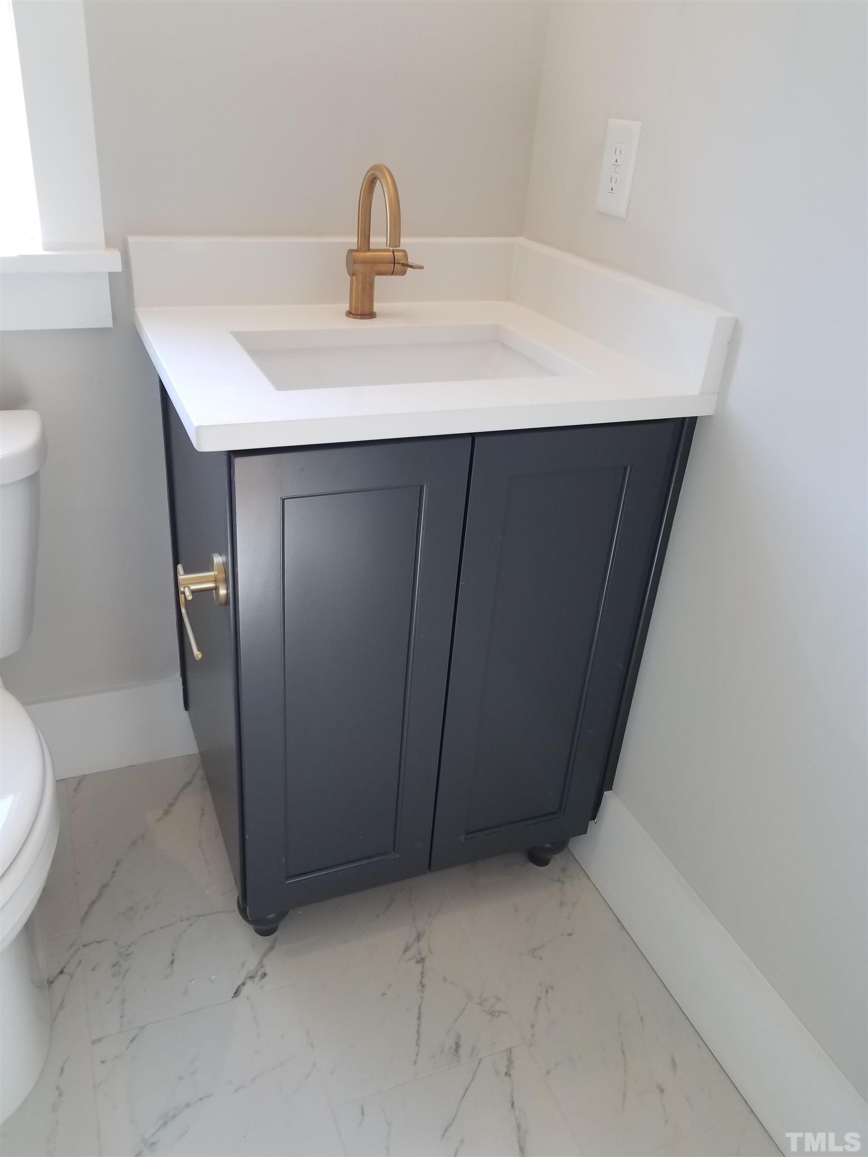 1304 Azalea Drive Raleigh, NC 27607 - Photo 21 of 26 a bathroom with a sink and a toilet