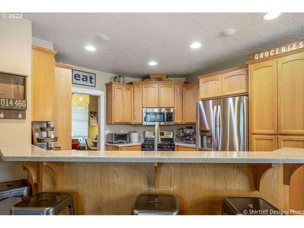 7184 F Place Springfield, OR 97478 - Photo 2 of 32 a kitchen with stainless steel appliances granite countertop a sink and a refrigerator
