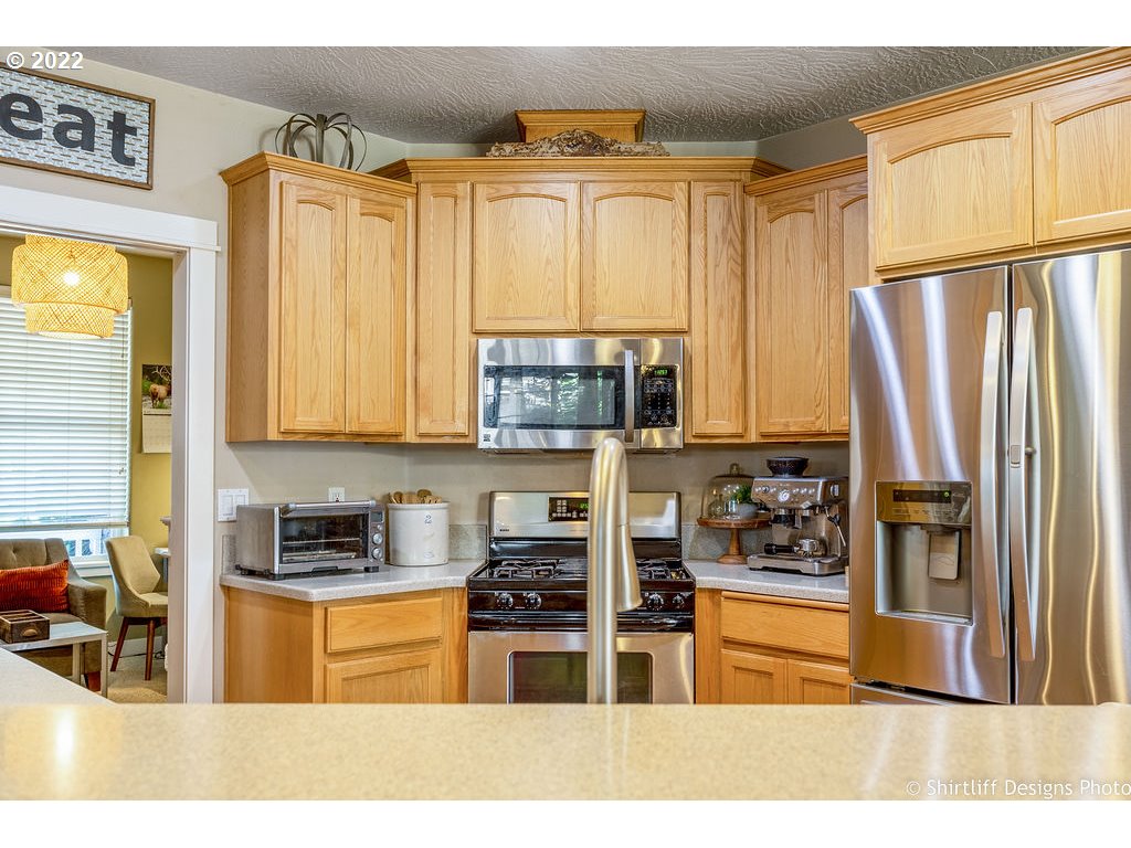 7184 F Place Springfield, OR 97478 - Photo 3 of 32 a kitchen with stainless steel appliances a refrigerator sink and cabinets