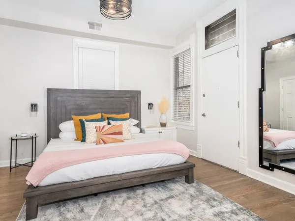 a bedroom with a bed and a mirror