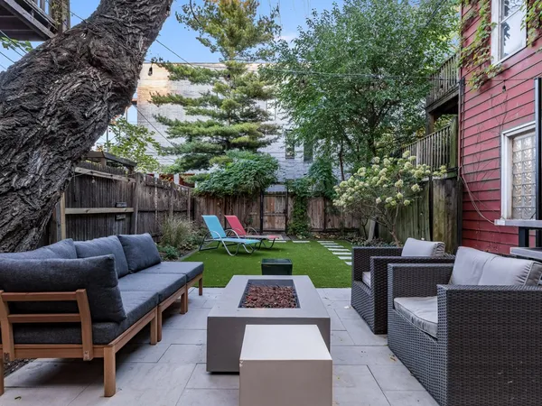 a view of backyard with outdoor seating and green space