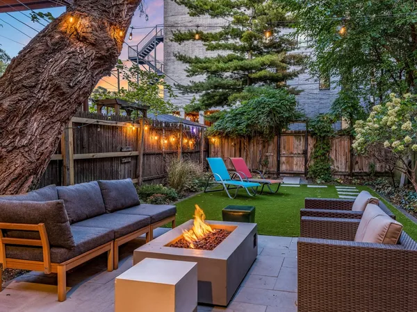 a view of backyard with seating area and green space