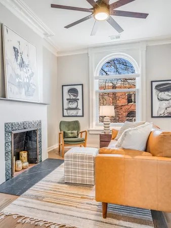 a living room with furniture and a fireplace
