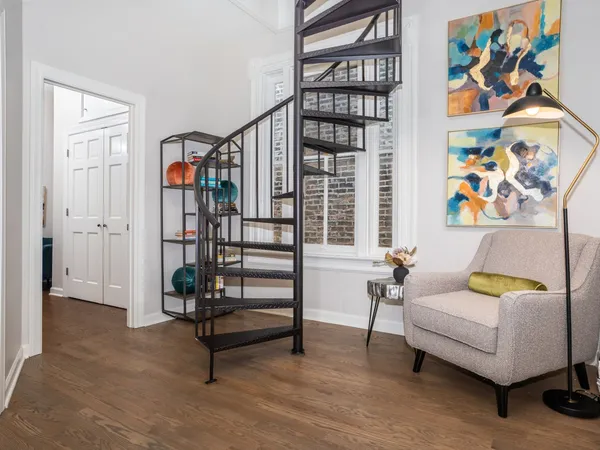 a living room with furniture and painting on the wall