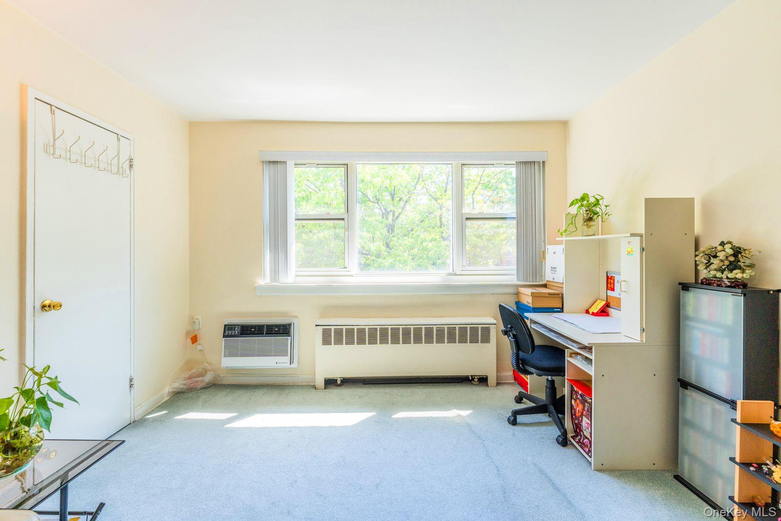 69-28 Kissena Boulevard, Unit 130B Queens, NY 11367 - Photo 12 of 20 a room with a bed and a window