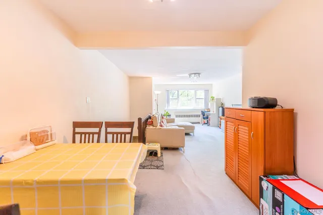 a spacious bedroom with a bed and wooden floor