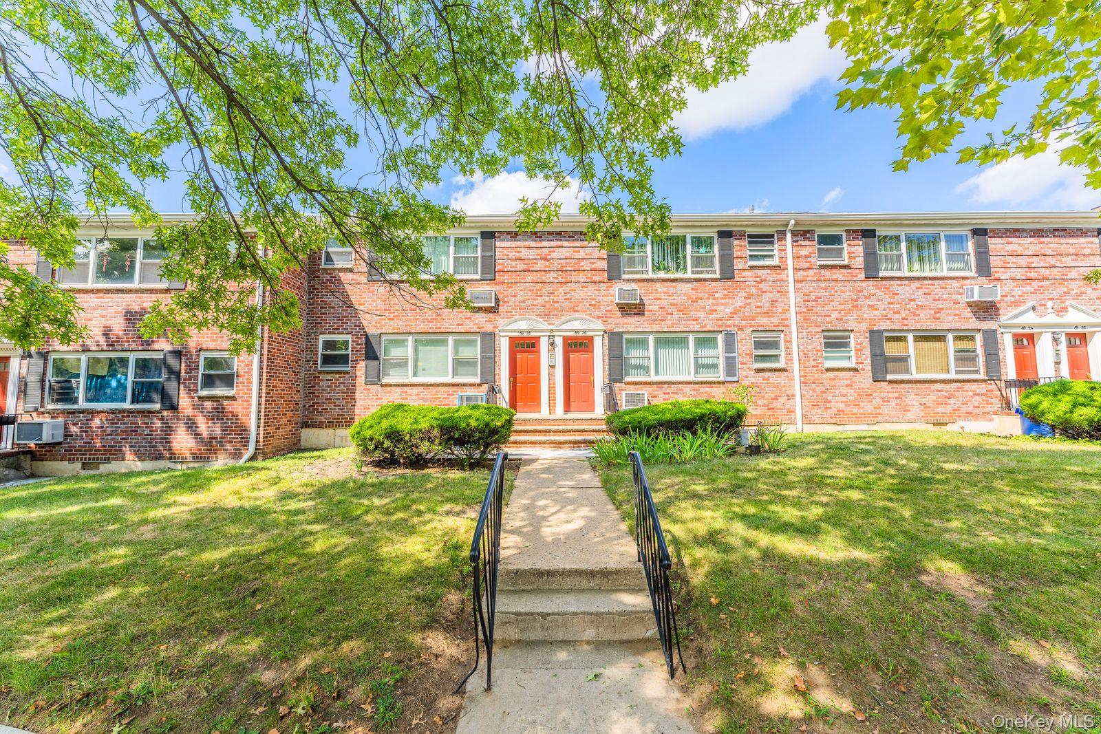 69-28 Kissena Boulevard, Unit 130B Queens, NY 11367 - Photo 2 of 20 a front view of a house with a yard