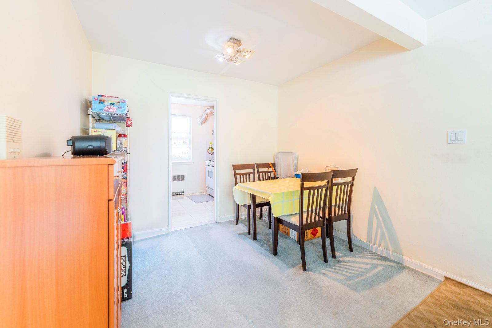 69-28 Kissena Boulevard, Unit 130B Queens, NY 11367 - Photo 8 of 20 a dining room with furniture and a chandelier