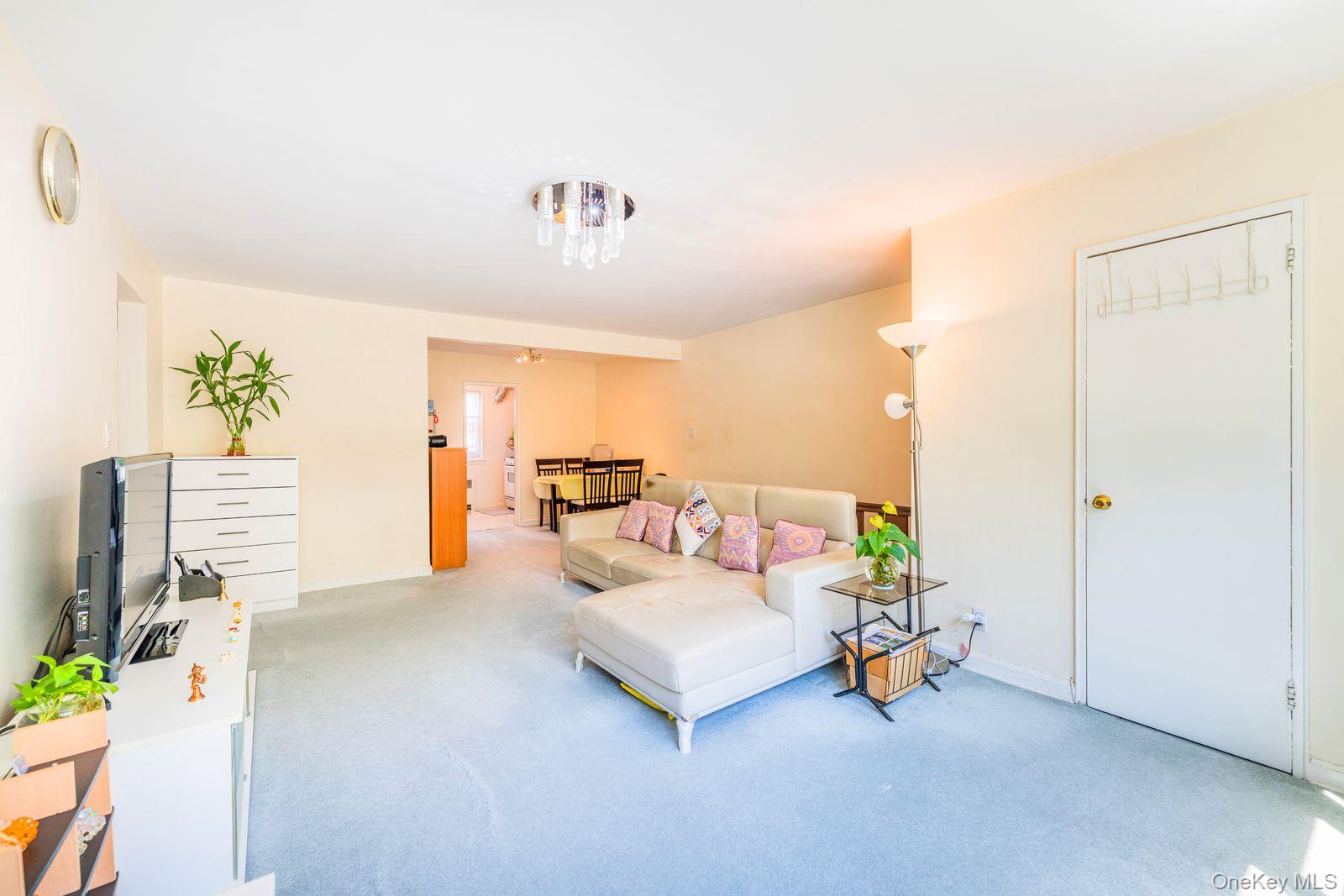 69-28 Kissena Boulevard, Unit 130B Queens, NY 11367 - Photo 10 of 20 a living room with furniture and a table