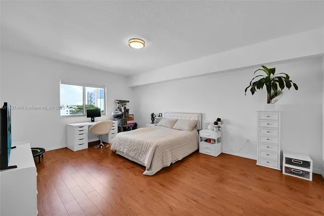 a spacious bedroom with a bed and a couch